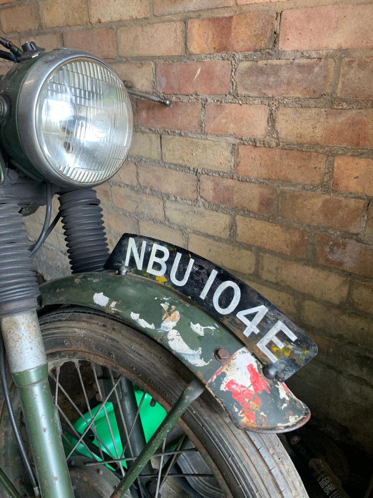 Motorcycle number plate painted in 'patina' style
