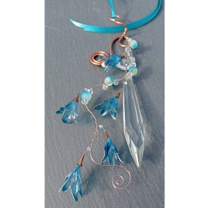 spring Springtime inspired suncatcher. The flowers are resin dipped wire, vintage crystal, glass beads and copper wire.